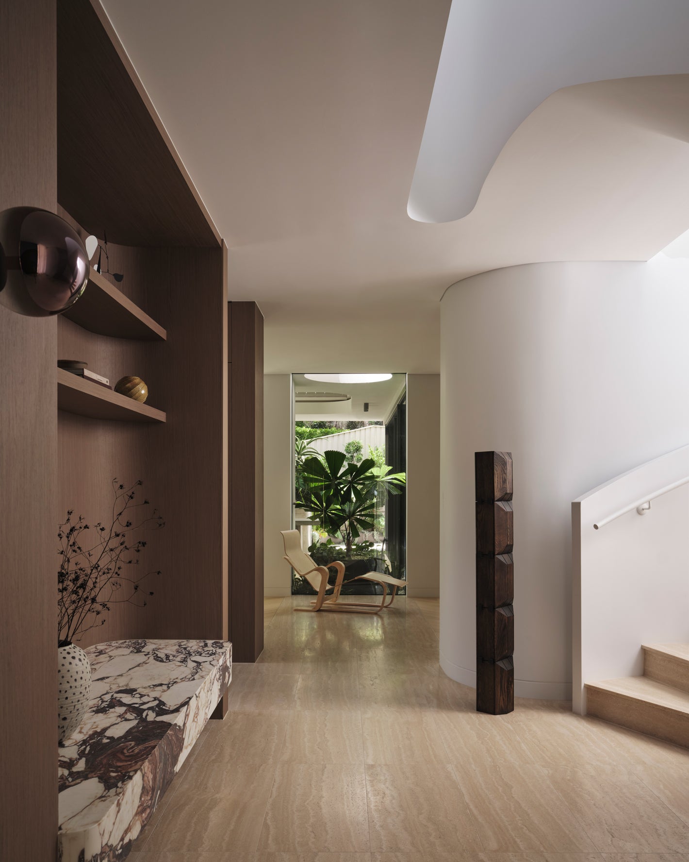 Curved walls travertine and Calacatta Viola marble, refined interior warm timber joinery in an architecturally designed home in Mosman, Sydney.